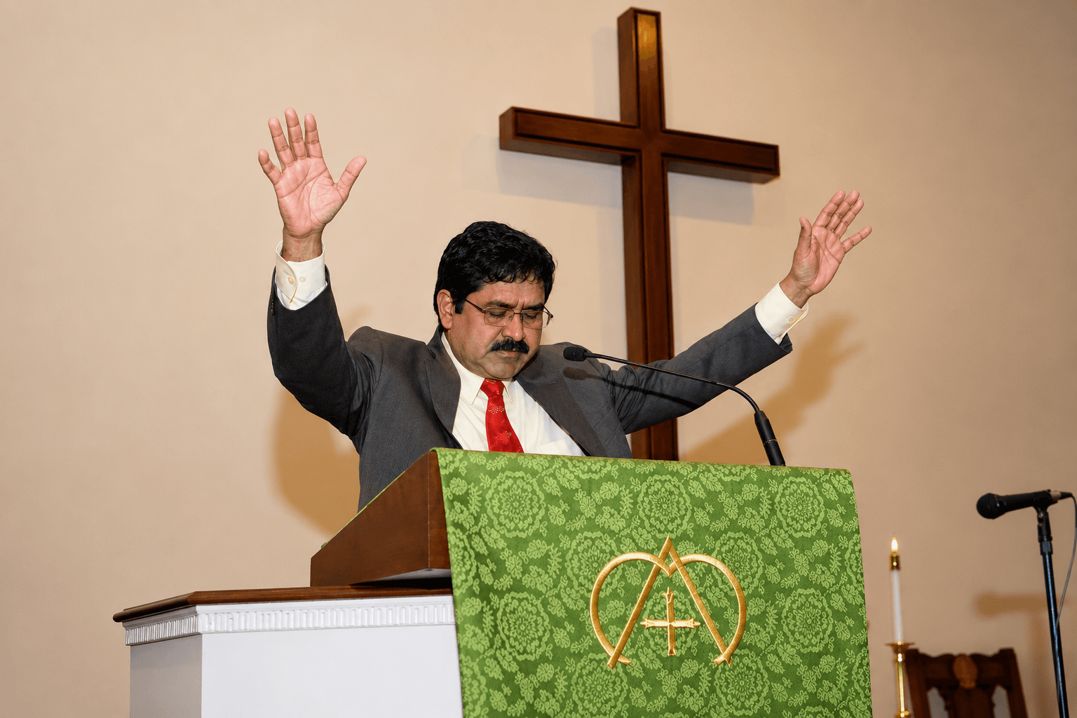 Pastor praying with raised hands